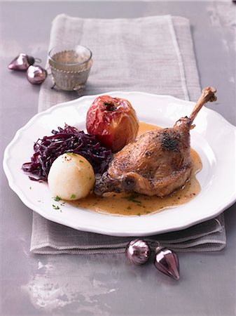 simsearch:659-01857024,k - Goose leg with a baked apple, red cabbage and a potato dumpling Stock Photo - Premium Royalty-Free, Code: 659-08512794