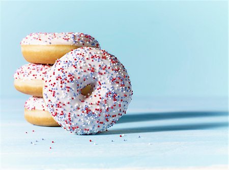 frosted - Doughnuts with white icing and colourful sugar sprinkles Stock Photo - Premium Royalty-Free, Code: 659-08512810