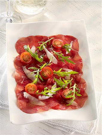 simsearch:659-07597225,k - Beef carpaccio with cherry tomatoes, rocket and Parmesan cheese Stock Photo - Premium Royalty-Free, Code: 659-08512946