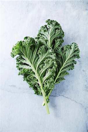 Fresh organic kale leaves on a marble background Stock Photo - Premium Royalty-Free, Code: 659-08895335