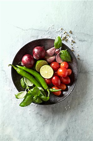 food still life - Vegetables, basil and lime for a vegetable dish on a plate Stock Photo - Premium Royalty-Free, Code: 659-08895630