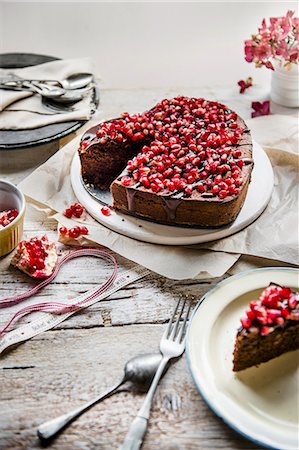 simsearch:659-06185283,k - Chocolate cake in a shape of a heart with chocolate glaze and pomegranate seeds Stock Photo - Premium Royalty-Free, Code: 659-08896458