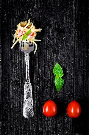 simsearch:659-08940768,k - Italian pasta with tomato and basil on fork On wooden board Stock Photo - Premium Royalty-Free, Code: 659-08896760
