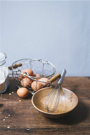 simsearch:659-06306291,k - an arrangement of eggs in a wire basket and a wooden bowl with a whisk Stock Photo - Premium Royalty-Free, Code: 659-08905275