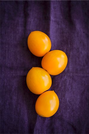 simsearch:659-08419643,k - Four yellow tomatoes on a violet cloth Stock Photo - Premium Royalty-Free, Code: 659-08905321