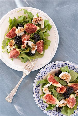 simsearch:659-07597225,k - Rocket salad with figs, blackberries, goats' cheese, walnuts and prosciutto Stock Photo - Premium Royalty-Free, Code: 659-08905379