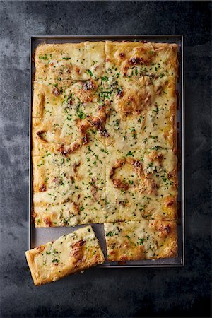 Four-cheese pizza on a baking tray Stock Photo - Premium Royalty-Free, Code: 659-08905788