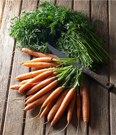 simsearch:659-07609605,k - A bunch of carrots with leaves and a knife on a wooden table Stock Photo - Premium Royalty-Free, Code: 659-08905860