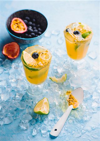 simsearch:659-06495307,k - An orange drink with passionfruit, lime and blueberries Stock Photo - Premium Royalty-Free, Code: 659-08905918