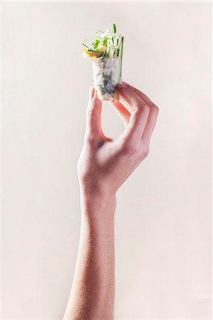 A hand holding a spring roll Stock Photo - Premium Royalty-Free, Code: 659-08940079
