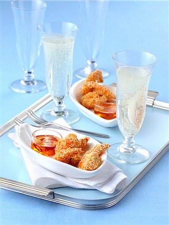 Fried sesame seed prawns with a chilli dip and glasses of champagne Stock Photo - Premium Royalty-Free, Code: 659-08940366