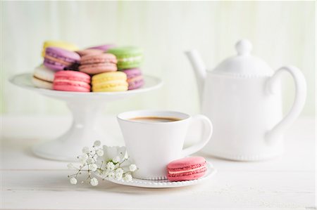 Colourful macaroons with coffee on a white table Stock Photo - Premium Royalty-Free, Code: 659-08940477