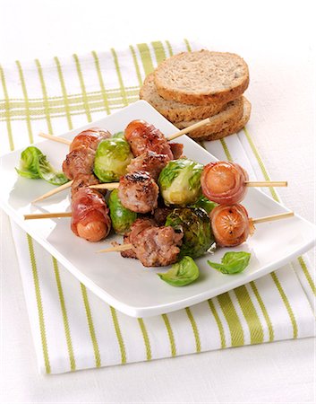simsearch:659-07597225,k - Sausages wrapped in bacon and Brussels sprouts on skewers Stock Photo - Premium Royalty-Free, Code: 659-08940770