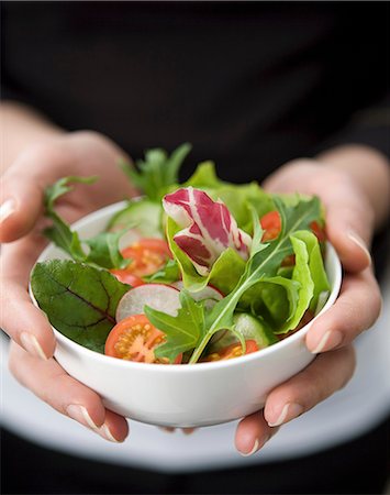 Hands holding a small white ball with mixed salad Stock Photo - Premium Royalty-Free, Code: 659-09125935
