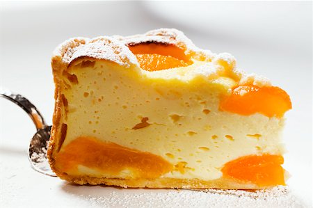 Piece of cheesecake with apricots on cake slice Stock Photo - Premium Royalty-Free, Code: 659-01845509