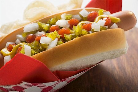 snacks hot dog - Hot dog with relish, mustard, ketchup, onions and crisps Stock Photo - Premium Royalty-Free, Code: 659-01847330