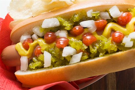 snacks hot dog - Hot dog with relish, mustard, ketchup, onions and crisps Stock Photo - Premium Royalty-Free, Code: 659-01847333