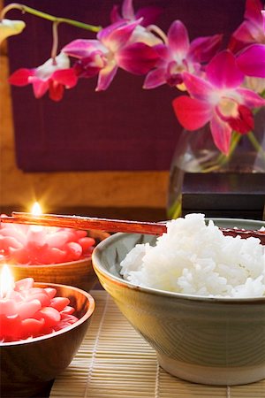 Bowl of rice beside burning candles (Thailand) Stock Photo - Premium Royalty-Free, Code: 659-01847825