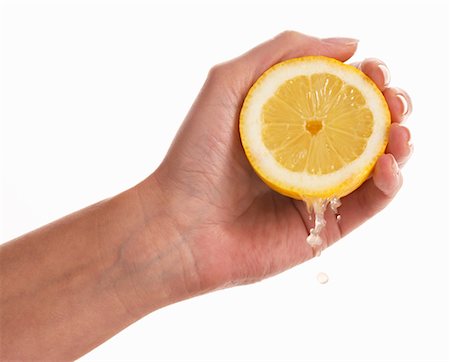 single lemon - Woman's hand squeezing a lemon Stock Photo - Premium Royalty-Free, Code: 659-01849044