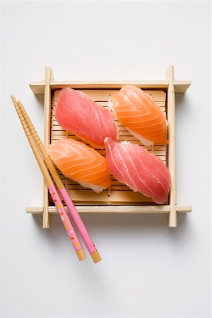 simsearch:659-07610354,k - Nigiri sushi with chopsticks on bamboo mat Stock Photo - Premium Royalty-Free, Code: 659-01849617