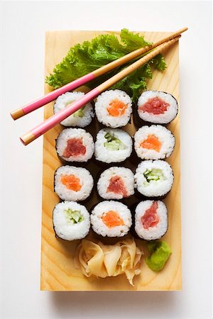 Maki sushi with fish and cucumber on sushi board Stock Photo - Premium Royalty-Free, Code: 659-01849647