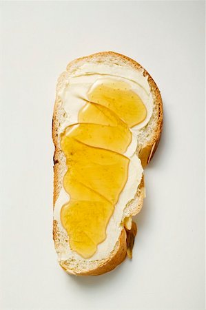 Slice of bread plait with butter and honey Stock Photo - Premium Royalty-Free, Code: 659-01849957