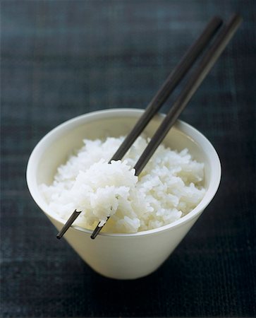 A Bowl of Cooked Jasmine Rice with Chopsticks Stock Photo - Premium Royalty-Free, Code: 659-01842752