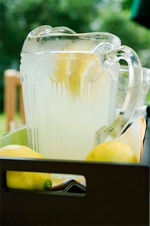 Lemonade in a glass jug with slices of lemon Stock Photo - Premium Royalty-Free, Code: 659-01854122