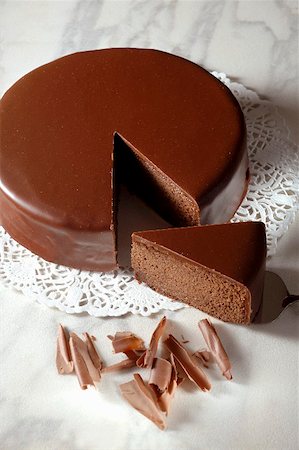 Sachertorte (Austrian chocolate cake) with a piece cut Stock Photo - Premium Royalty-Free, Code: 659-01856232