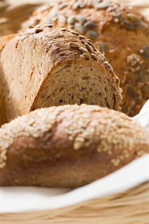 Three different loaves of bread in bread basket Stock Photo - Premium Royalty-Free, Code: 659-01856677