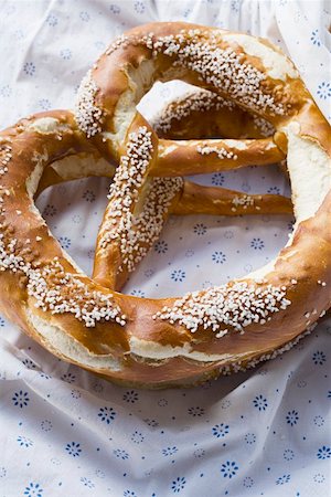 soft pretzel food photography - Two Bavarian salted pretzels Stock Photo - Premium Royalty-Free, Code: 659-01857377