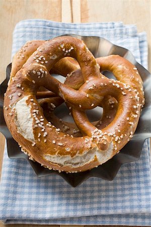 soft pretzel food photography - Two salted pretzels on blue and white checked cloth Stock Photo - Premium Royalty-Free, Code: 659-01857452