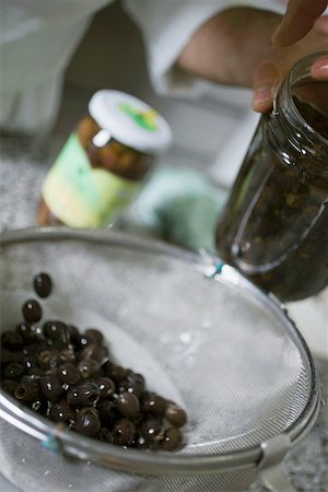 simsearch:659-06188604,k - Draining black olives in a sieve Stock Photo - Premium Royalty-Free, Code: 659-01858287