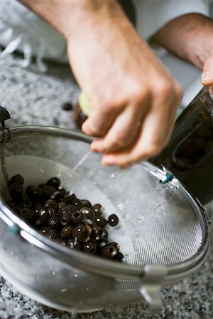 simsearch:659-06188604,k - Draining black olives in a sieve Stock Photo - Premium Royalty-Free, Code: 659-01858288