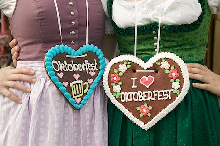 Two women in national dress with Lebkuchen hearts at Oktoberfest Stock Photo - Premium Royalty-Free, Code: 659-01859644