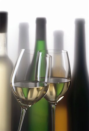 simsearch:659-06186663,k - Two glasses of white wine in front of white wine bottles Stock Photo - Premium Royalty-Free, Code: 659-01850057