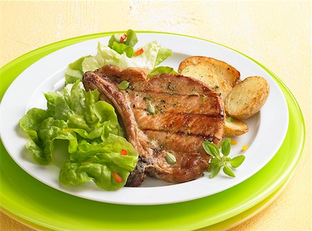 porkchop - Grilled pork chop with fried potatoes Stock Photo - Premium Royalty-Free, Code: 659-01850845