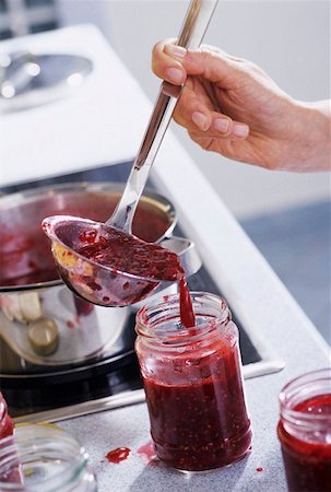 Raspberry jam being ladled into a screw-top jar Stock Photo - Premium Royalty-Free, Code: 659-01851727