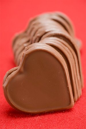 simsearch:659-06151276,k - Chocolate hearts on red background Stock Photo - Premium Royalty-Free, Code: 659-01864469