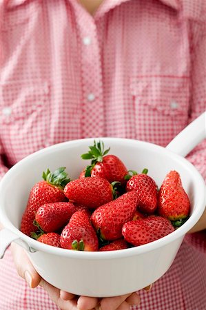simsearch:659-06186270,k - Woman holding strainer full of strawberries Stock Photo - Premium Royalty-Free, Code: 659-01864508