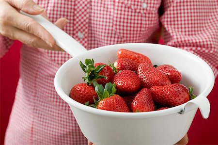 simsearch:659-06186270,k - Woman holding strainer full of strawberries Stock Photo - Premium Royalty-Free, Code: 659-01864509