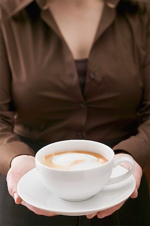 Woman holding large cup of cappuccino Stock Photo - Premium Royalty-Free, Code: 659-01865399