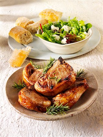 porkchop - Grilled pork chops with rosemary, salad leaves and bread Stock Photo - Premium Royalty-Free, Code: 659-01866059