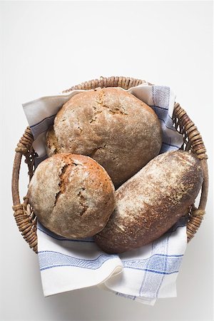 rye bread - Three rustic loaves of bread in a bread basket Stock Photo - Premium Royalty-Free, Code: 659-01866610