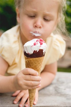 Small girl eating ice cream cone Stock Photo - Premium Royalty-Free, Code: 659-01866683