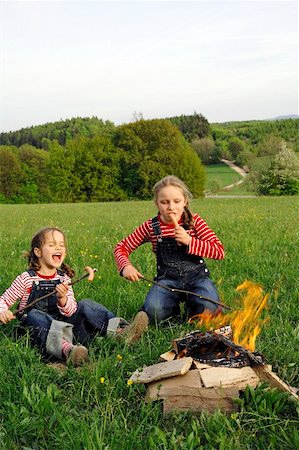 summer camping fire - Two girls grilling sausages over a camp-fire Stock Photo - Premium Royalty-Free, Code: 659-01867355