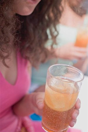 Woman holding a glass of iced tea Stock Photo - Premium Royalty-Free, Code: 659-01867661