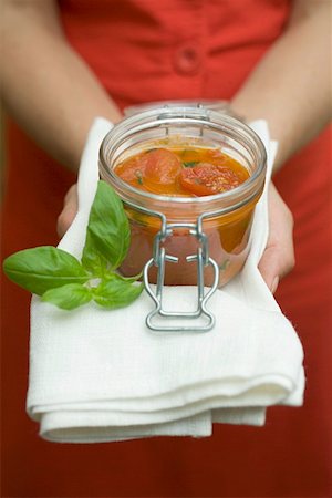 Hands holding preserving jar of tomato sauce Stock Photo - Premium Royalty-Free, Code: 659-01860526