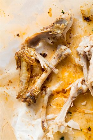 Remains of roast chicken on paper Stock Photo - Premium Royalty-Free, Code: 659-01862263