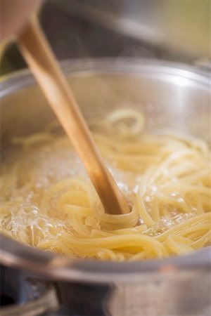 Stirring ribbon pasta during cooking Stock Photo - Premium Royalty-Free, Code: 659-01863671